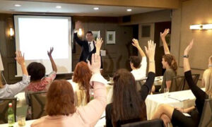 chiropractor hypnotherapist Dr. Theo Kousouli teaches enthusiastic 'Be A Master' seminar attendees how to uncover inborn gifts of mind-body, or advanced 'psychic' skills.